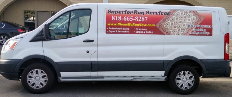 A white van with the words " superior ray service " on it.