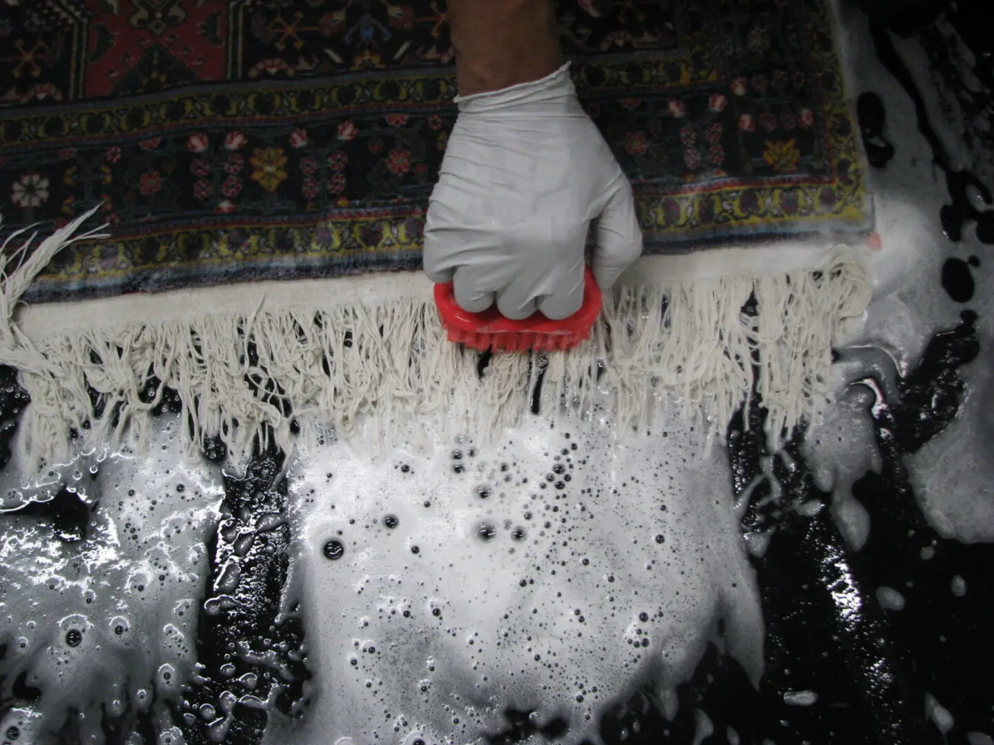 washing the fringes before the rug cleaning ends